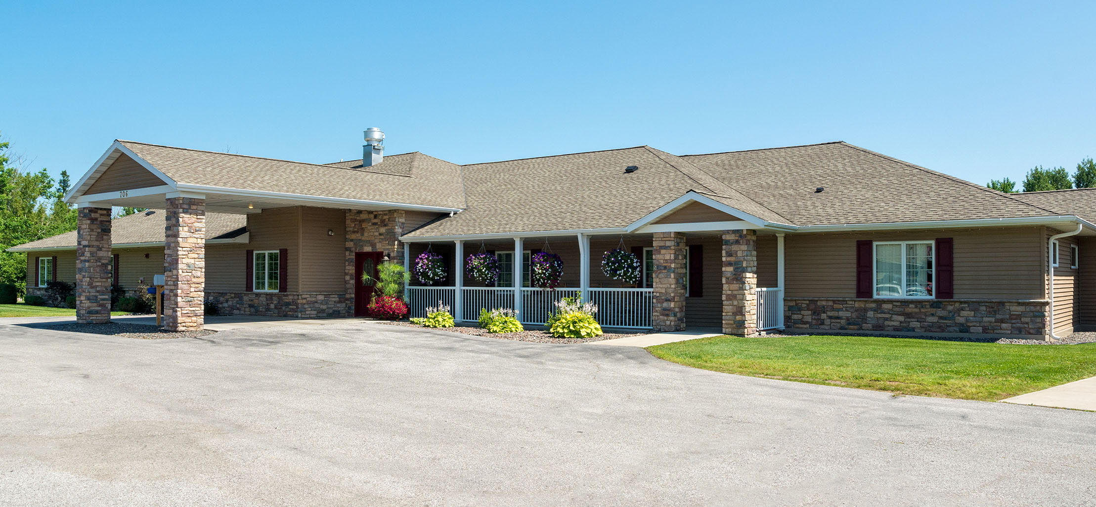 exterior of Cloquet facility with stone and dark brown siding - New Perspective Careers Assisted Living Careers