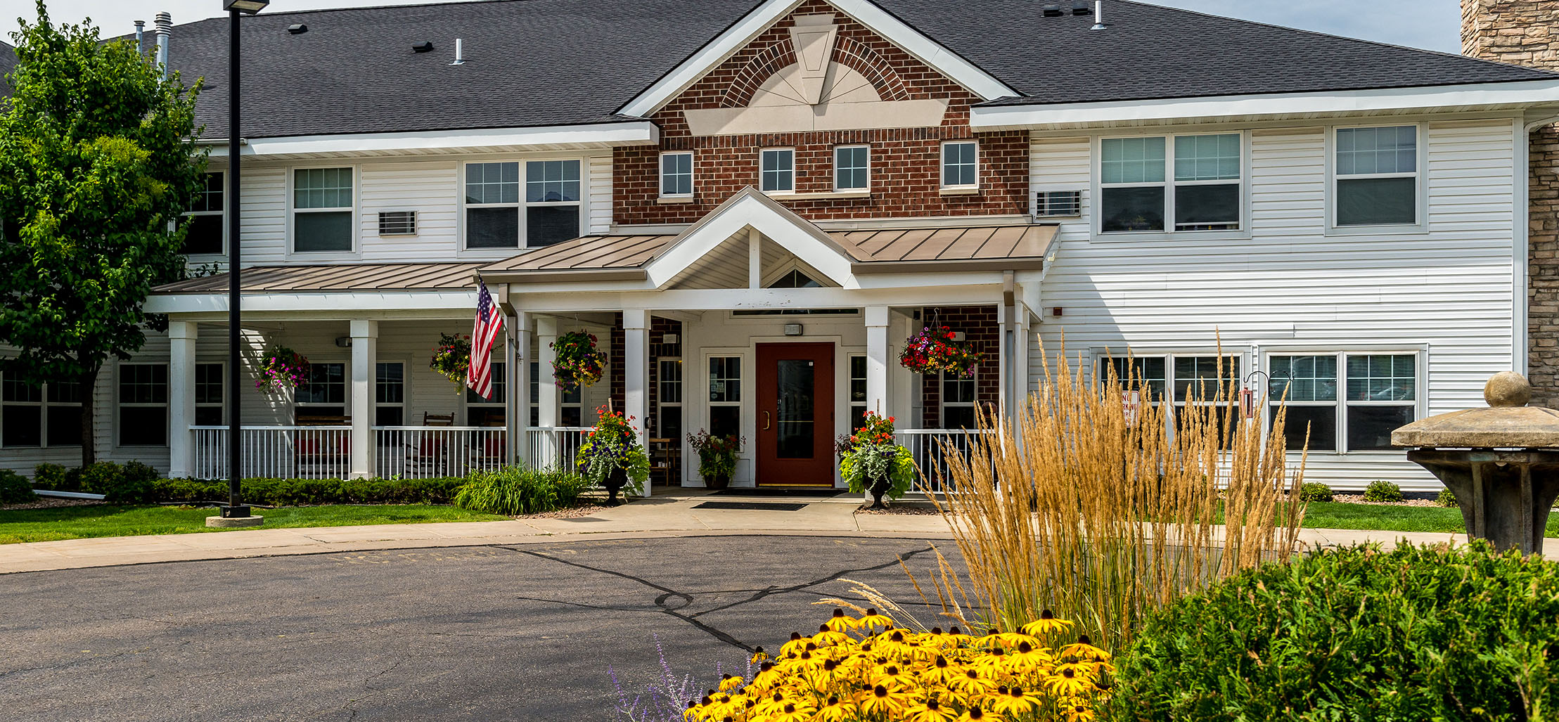 exterior of Faribault facility with brick and white siding - New Perspective Careers Assisted Living Careers