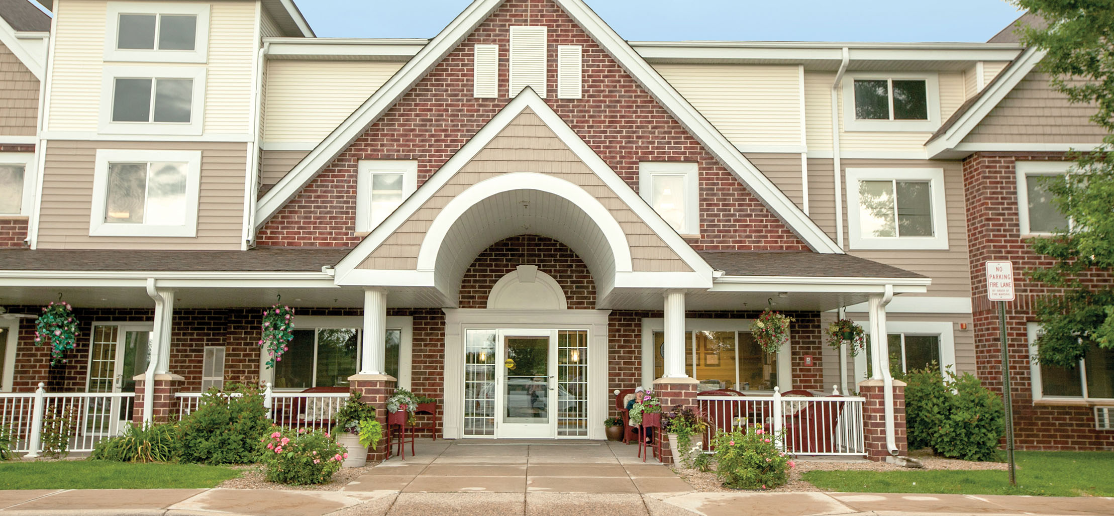 exterior of Prior Lake facility with red brick and light yellow siding - New Perspective Careers Assisted Living Careers